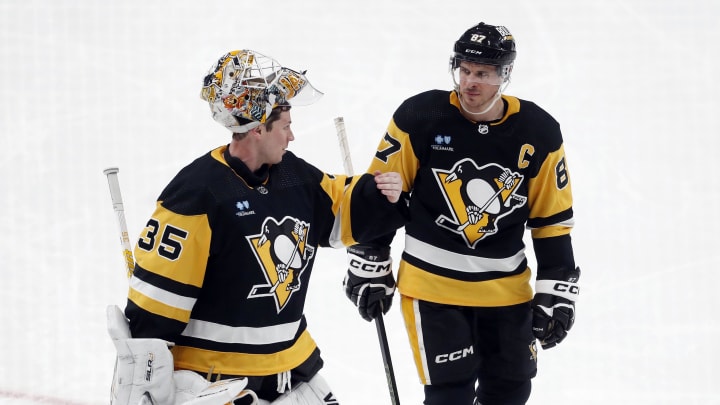 Feb 6, 2024; Pittsburgh, Pennsylvania, USA;  Pittsburgh Penguins goaltender Tristan Jarry (35) and center Sidney Crosby (87) talk during a time-out against the Winnipeg Jets in the third period at PPG Paints Arena. The Penguins shutout the Jets 3-0. Mandatory Credit: Charles LeClaire-USA TODAY Sports