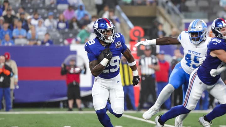 Aug 8, 2024; East Rutherford, New Jersey, USA;  New York Giants running back Tyrone Tracy Jr. (29) runs in the backfield against the Detroit Lions at MetLife Stadium. 