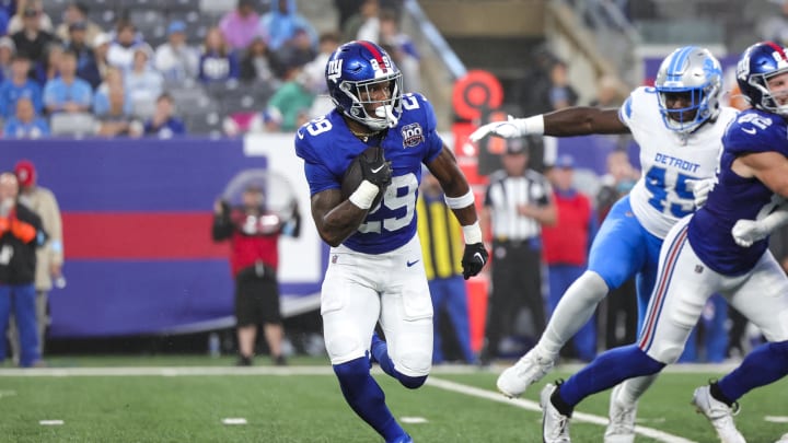 Aug 8, 2024; East Rutherford, New Jersey, USA;  New York Giants running back Tyrone Tracy Jr. (29) runs in the backfield against the Detroit Lions at MetLife Stadium. Mandatory Credit: Scott Rausenberger-USA TODAY Sports