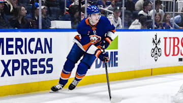 Apr 15, 2025; Elmont, New York, USA; New York Islanders defenseman Noah Dobson (8) skates with the puck during the third period against the Washington Capitals at UBS Arena. Mandatory Credit: John Jones-Imagn Images