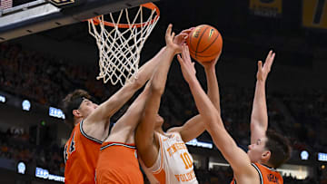 Dec 6, 2025; Nashville, Tennessee, USA;  Illinois Fighting Illini center Zvonimir Ivisic (44), guard Andrej Stojakovic (2), and forward David Mirkovic (0) blocks the shot of  Tennessee Volunteers forward Nate Ament (10) during the first half at Bridgestone Arena. Mandatory Credit: Steve Roberts-Imagn Images