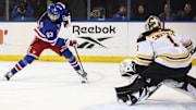Jan 2, 2025; New York, New York, USA;  Boston Bruins goaltender Jeremy Swayman (1) defends against a shot on goal attempt from New York Rangers center Mika Zibanejad (93) in the second period at Madison Square Garden. Mandatory Credit: Wendell Cruz-Imagn Images