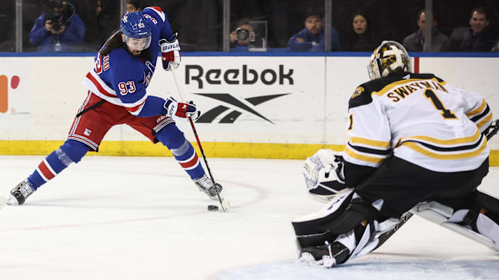 Jan 2, 2025; New York, New York, USA;  Boston Bruins goaltender Jeremy Swayman (1) defends against a shot on goal attempt from New York Rangers center Mika Zibanejad (93) in the second period at Madison Square Garden. Mandatory Credit: Wendell Cruz-Imagn Images