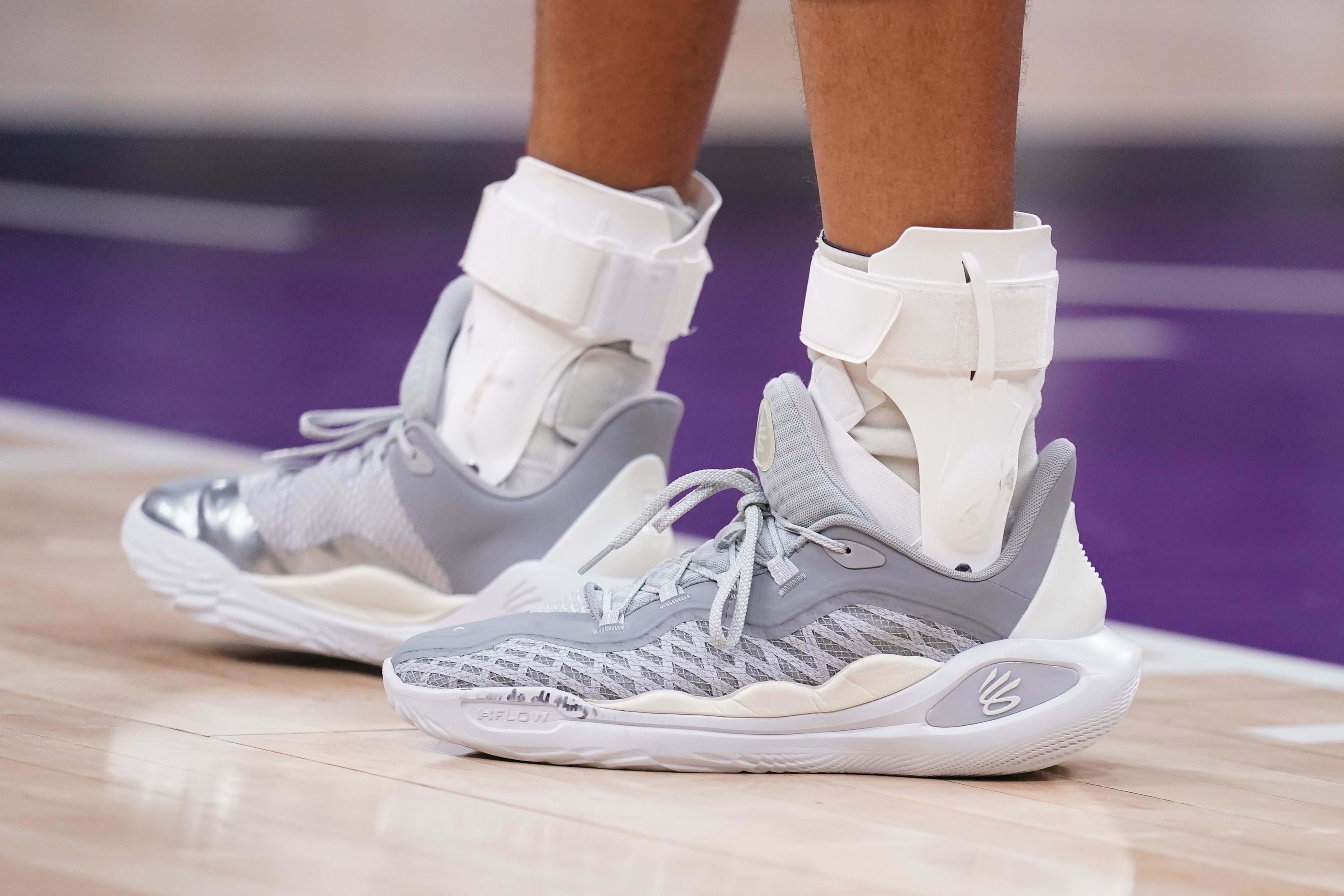 Golden State Warriors guard Stephen Curry's grey and white sneakers.