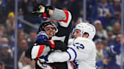 Dec 20, 2024; Buffalo, New York, USA;  Buffalo Sabres center Dylan Cozens (24) and Toronto Maple Leafs defenseman Jake McCabe (22) get into a scrum after the whistle during the second period at KeyBank Center. Mandatory Credit: Timothy T. Ludwig-Imagn Images