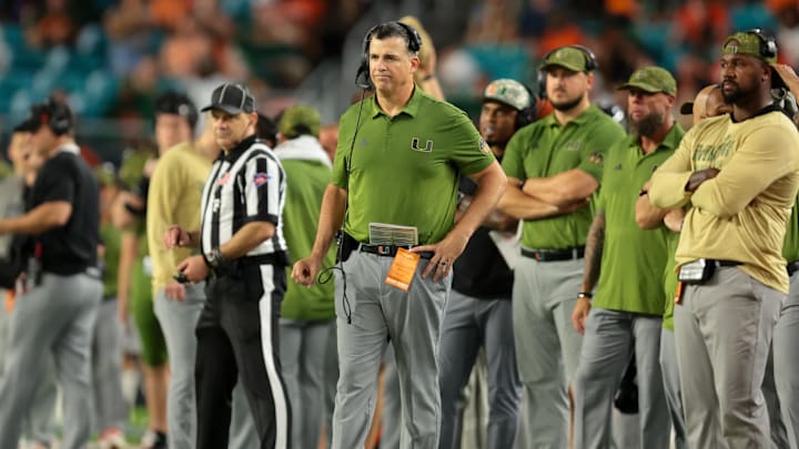 Oct 25, 2025; Miami Gardens, Florida, USA; Miami Hurricanes head coach Mario Cristobal watches from the sideline against the Stanford Cardinal during the fourth quarter at Hard Rock Stadium. Mandatory Credit: Sam Navarro-Imagn Images