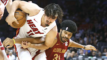 Nov 10, 2025; Miami, Florida, USA;  Miami Heat forward Jaime Jaquez Jr. (11) and Cleveland Cavaliers center Jarrett Allen (31) fight for a loose ball during the first period at Kaseya Center. Mandatory Credit: Rhona Wise-Imagn Images