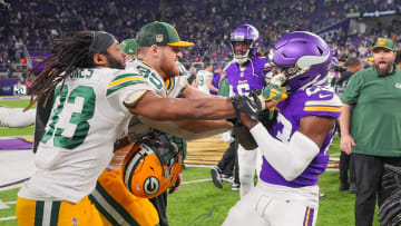 Former Green Bay Packers running back Aaron Jones (33) and Minnesota Vikings cornerback Andrew Booth Jr. (23) get into a scrap after last season's game.