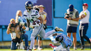 Nov 23, 2025; Nashville, Tennessee, USA; Seattle Seahawks wide receiver Jaxon Smith-Njigba (11) receives a pass for a touchdown in front of Tennessee Titans safety Amani Hooker (37) during the second quarter at Nissan Stadium. 