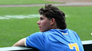 Jun 17, 2025; Omaha, Neb, USA;  UCLA Bruins third baseman Roman Martin (7) cheers action against the LSU Tigers during the eighth inning at Charles Schwab Field. Mandatory Credit: Steven Branscombe-Imagn Images