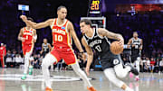 Oct 29, 2025; Brooklyn, New York, USA; Brooklyn Nets forward Michael Porter Jr. (17) looks to drive past Atlanta Hawks forward Zaccharie Risacher (10) in the second quarter at Barclays Center. Mandatory Credit: Wendell Cruz-Imagn Images