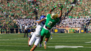 Notre Dame wide receiver Will Pauling makes a catch over Boise State Broncos defensive back Davon Banks.