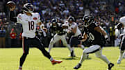 Oct 26, 2025; Baltimore, Maryland, USA; Chicago Bears quarterback Caleb Williams (18) passes the ball under pressure from Baltimore Ravens linebacker Teddye Buchanan (40) at M&T Bank Stadium. Mandatory Credit: Geoff Burke-Imagn Images