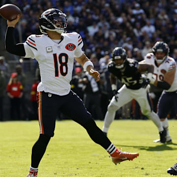 Oct 26, 2025; Baltimore, Maryland, USA; Chicago Bears quarterback Caleb Williams (18) passes the ball under pressure from Baltimore Ravens linebacker Teddye Buchanan (40) at M&T Bank Stadium. Mandatory Credit: Geoff Burke-Imagn Images