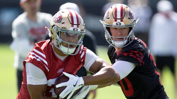 San Francisco 49ers running back Isaac Guerendo (31) takes a handoff from quarterback Mac Jones (10)