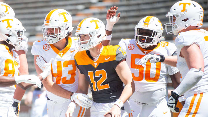 Teammates celebrate a touchdown by Tennessee quarterback Jake Merklinger (12) during Tennessee's Orange & White spring football game at Neyland Stadium on Saturday, April 13, 2024.