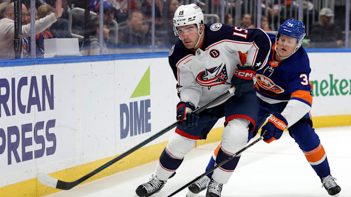 Mar 24, 2025; Elmont, New York, USA; Columbus Blue Jackets defenseman Dante Fabbro (15) skates with the puck against New York Islanders defenseman Adam Boqvist (34) during the second period at UBS Arena. Mandatory Credit: Brad Penner-Imagn Images Mar 24, 2025; Elmont, New York, USA; Columbus Blue Jackets defenseman Dante Fabbro (15) skates with the puck against New York Islanders defenseman Adam Boqvist (34) during the second period at UBS Arena. Mandatory Credit: Brad Penner-Imagn Images