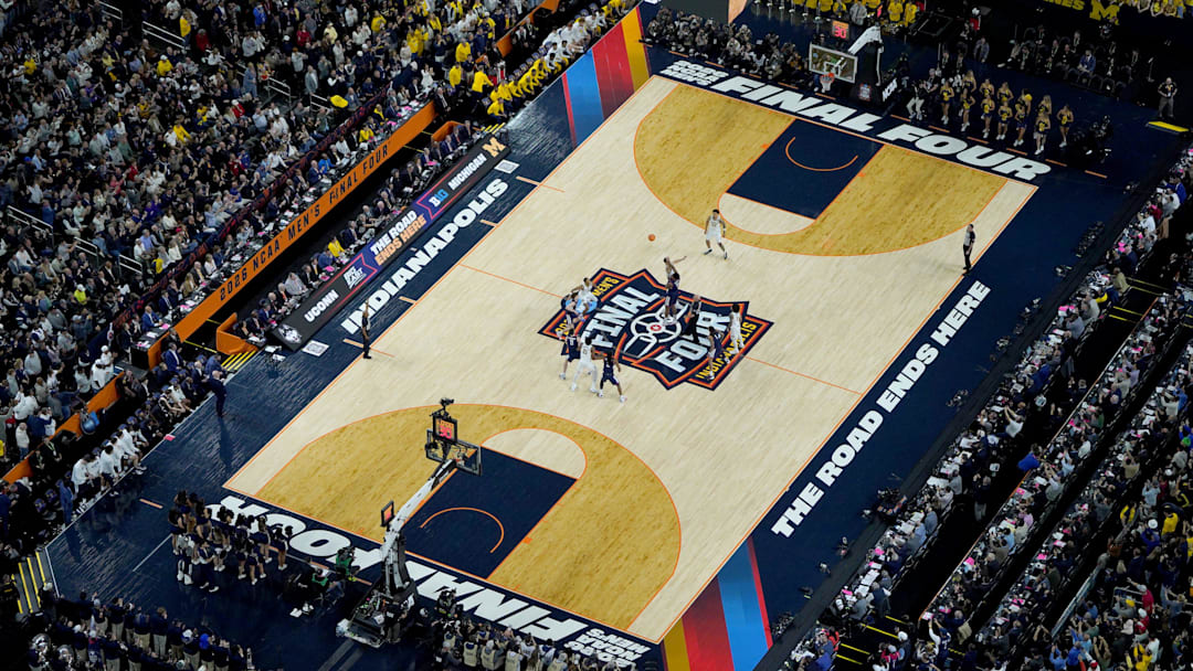 Michigan Wolverines center Aday Mara (15) and UConn Huskies forward Tarris Reed Jr. (5) tip off Monday, April 6, 2026, during the NCAA Men's Basketball Tournament National Championship game at Lucas Oil Stadium in Indianapolis.