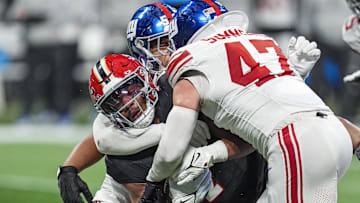 Dec 22, 2024; Atlanta, Georgia, USA; Atlanta Falcons running back Bijan Robinson (7) is tackled by New York Giants linebacker Darius Muasau (53) and linebacker Ty Summers (47) during the second half at Mercedes-Benz Stadium.   