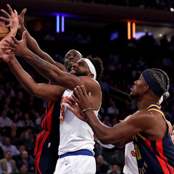 Mar 4, 2025; New York, New York, USA; New York Knicks center Mitchell Robinson (23) fights for a rebound against Golden State Warriors guard Stephen Curry (30) and forwards Draymond Green (23) and Jimmy Butler III (10) during the third quarter at Madison Square Garden. Mandatory Credit: Brad Penner-Imagn Images
