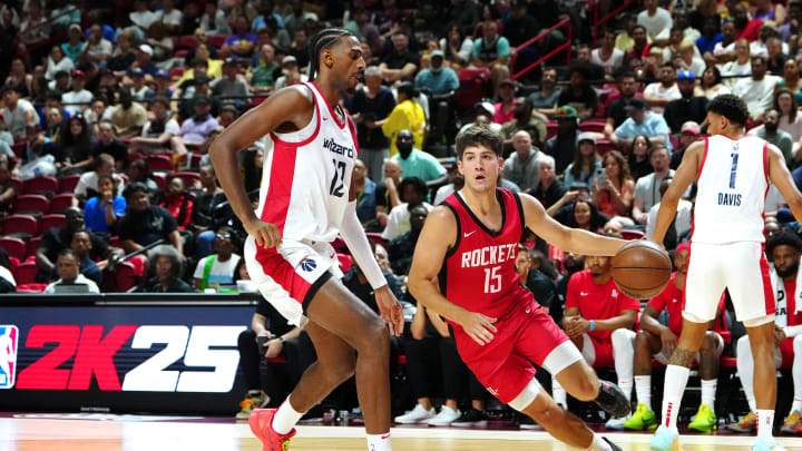 Jul 14, 2024; Las Vegas, NV, USA; Houston Rockets guard Reed Sheppard (15) dribbles around Washington Wizards forward Alex Sarr (12) during the third quarter at Thomas & Mack Center. Mandatory Credit: Stephen R. Sylvanie-USA TODAY Sports