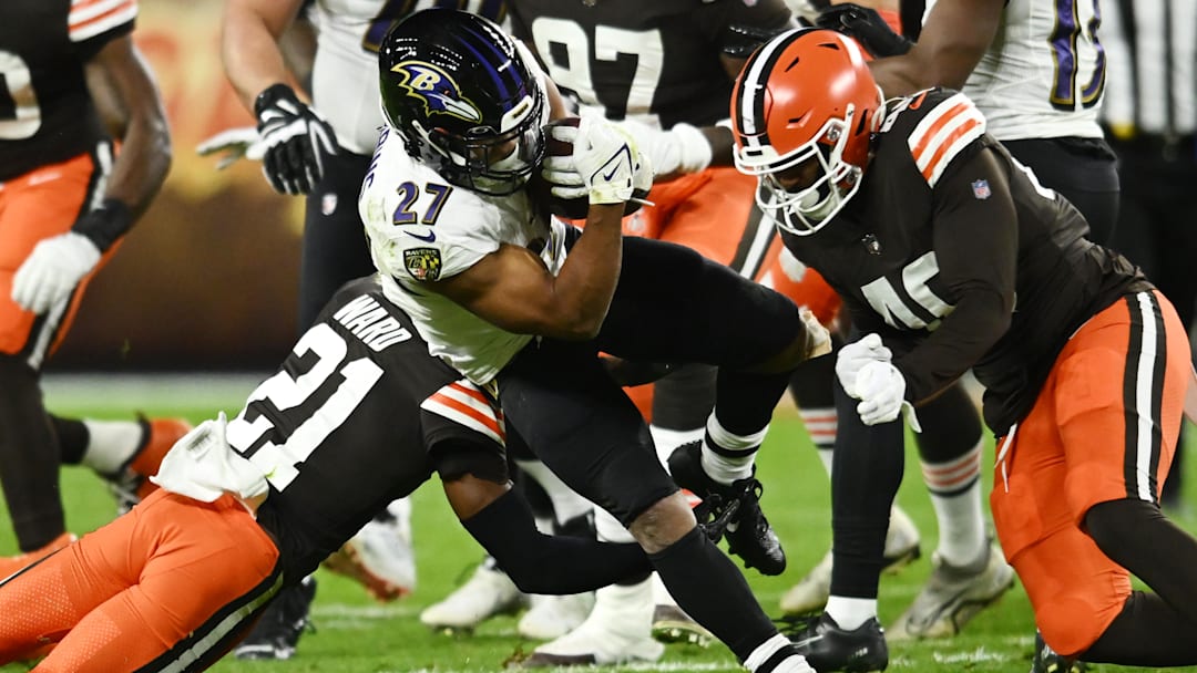 Cleveland Browns cornerback Denzel Ward (21) and linebacker Jermaine Carter (40) tackle Baltimore Ravens running back J.K. Dobbins (27) during the first half at FirstEnergy Stadium. 