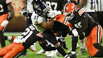Cleveland Browns cornerback Denzel Ward (21) and linebacker Jermaine Carter (40) tackle Baltimore Ravens running back J.K. Dobbins (27) during the first half at FirstEnergy Stadium. 
