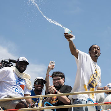 Jun 24, 2025; Oklahoma City, OK, USA;  Oklahoma City Thunder player Jalen Williams splashes water on fans during the 2025 NBA Oklahoma City Thunder championship parade. Mandatory Credit: Brett Rojo-Imagn Images