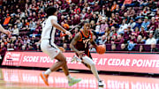 Feb. 15, 2025; Blacksburg, Va.; Virginia Tech forward Tobi Lawal (1) drives toward the basket as Virginia forward Jacob Cofie (5) defends.