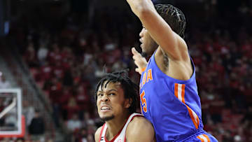 Jan 11, 2025; Fayetteville, Arkansas, USA; Arkansas Razorbacks guard D.J. Wagner (21) drives in the first half against Florida Gators guard Alijah Martin (15) at Bud Walton Arena. Mandatory Credit: Nelson Chenault-Imagn Images