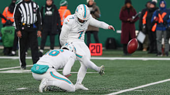 Miami Dolphins place kicker Jason Sanders (7) kicks a field goal as punter Jake Bailey (16) holds during the first quarter against the New York Jets at MetLife Stadium. 