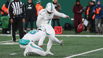 Miami Dolphins place kicker Jason Sanders (7) kicks a field goal as punter Jake Bailey (16) holds during the first quarter against the New York Jets at MetLife Stadium. 