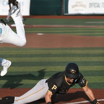 Daytona Tortugas third baseman Carlos Sanchez (33) jumps over sliding Bradenton Marauders player Konnor Griffin (6), Friday, April 4, 2025 at Jackie Robinson Ballpark in Daytona Beach.
