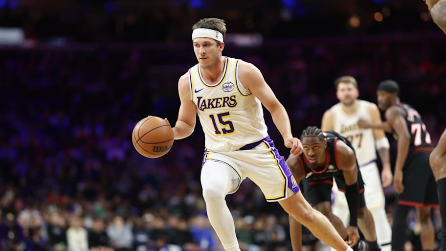 Lakers guard Austin Reaves dribbles past 76ers guard Tyrese Maxey.