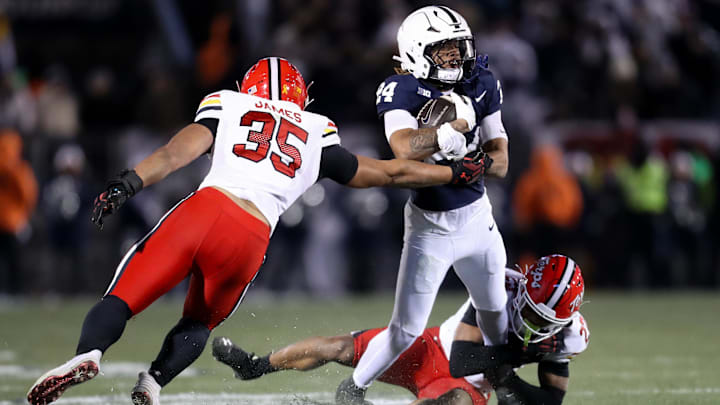 Nov 30, 2024; University Park, Pennsylvania, USA; Penn State Nittany Lions running back Corey Smith (24) runs the ball against Maryland Terrapins defensive back Jalen Huskey (22) during the third quarter at Beaver Stadium. Penn State won 44-7. Mandatory Credit: Matthew O'Haren-Imagn Images