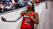 Washington Mystics forward Aaliyah Edwards takes a photo with a during the game against the Indiana Fever. 