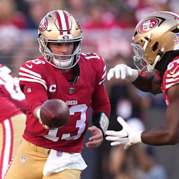 Sep 9, 2024; Santa Clara, California, USA; San Francisco 49ers quarterback Brock Purdy (13) hands off to running back Jordan Mason (right) during the second quarter at Levi's Stadium. Mandatory Credit: Darren Yamashita-Imagn Images