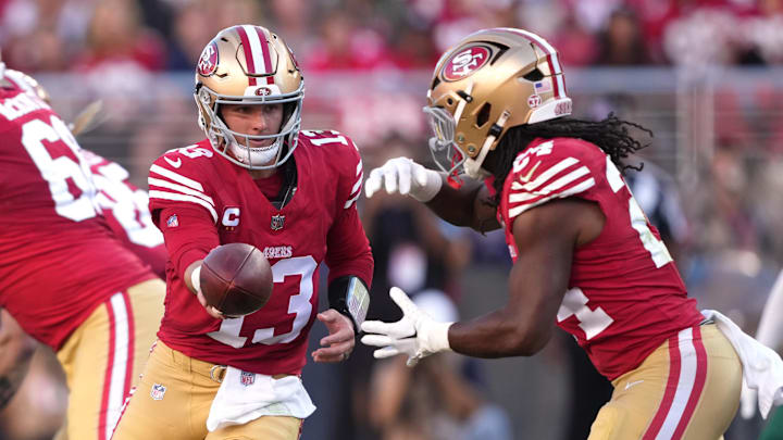 Sep 9, 2024; Santa Clara, California, USA; San Francisco 49ers quarterback Brock Purdy (13) hands off to running back Jordan Mason (right) during the second quarter at Levi's Stadium. Mandatory Credit: Darren Yamashita-Imagn Images