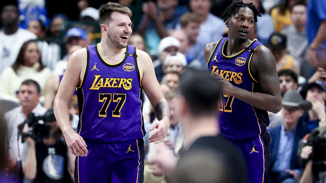 Los Angeles Lakers guard Luka Doncic (77) laughs with forward Dorian Finney-Smith (17) against the Dallas Mavericks during the second half at American Airlines Center.