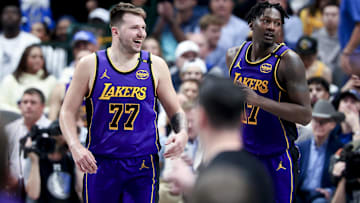Los Angeles Lakers guard Luka Doncic (77) laughs with forward Dorian Finney-Smith (17) against the Dallas Mavericks during the second half at American Airlines Center.