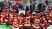 Apr 9, 2022; Boston, MA, USA; Denver Pioneers head coach David Carle talks with his team during a timeout during the third period of the 2022 Frozen Four college ice hockey national championship game against the Minnesota State Mavericks at TD Garden. Mandatory Credit: Brian Fluharty-Imagn Images