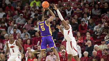 Feb 12, 2025; Fayetteville, Arkansas, USA;  LSU Tigers guard Cam Carter (5) shoots over Arkansas Razorbacks forward Adou Thiero (3) during the second half at Bud Walton Arena. Arkansas won 70-58. Mandatory Credit: Brett Rojo-Imagn Images