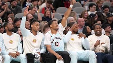 Mar 21, 2025; San Antonio, Texas, USA; San Antonio Spurs forward Keldon Johnson (0) and guard Devin Vassell (24) react to a basket during the fourth quarter against the Philadelphia 76ers at Frost Bank Center. Mandatory Credit: Dustin Safranek-Imagn Images