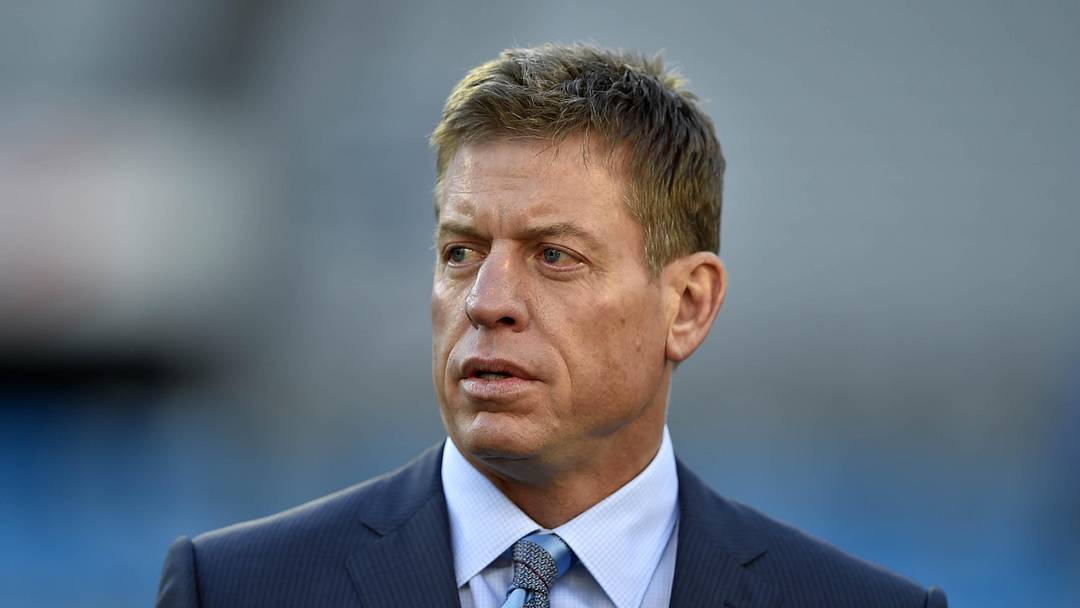 Jan 24, 2016; Charlotte, NC, USA; Fox Sports analyst Troy Aikman on the field before the game between the Carolina Panthers and the Arizona Cardinals in the NFC Championship football game at Bank of America Stadium. Mandatory Credit: Bob Donnan-Imagn Images