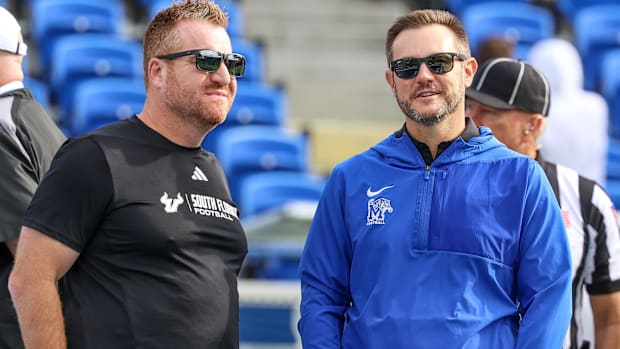 South Florida Bulls coach Alex Golesh talks with Memphis Tigers coach Ryan Silverfield 