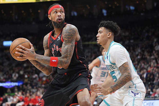 Raptors forward Brandon Ingram looks to make a play as Hornets guard KJ Simpson defends..