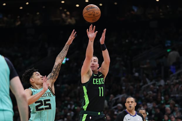 Boston Celtics guard Payton Pritchard (11) shoots during the first half against the Charlotte Hornets at TD Garden.