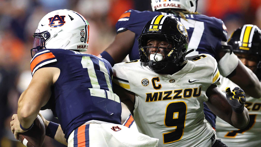 Oct 18, 2025; Auburn, Alabama, USA;  Missouri Tigers defensive end Zion Young (9) moves in to tackle Auburn Tigers quarterback Jackson Arnold (11) during the fourth quarter at Jordan-Hare Stadium.  Mandatory Credit: John Reed-Imagn Images