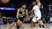 Nov 24, 2025; Memphis, Tennessee, USA; Denver Nuggets guard Jamal Murray (27) drives to the basket as Memphis Grizzlies forward Cedric Coward (23) defends during the first quarter at FedExForum. Mandatory Credit: Petre Thomas-Imagn Images