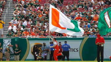 Sep 28, 2013; Tampa, FL, USA; Miami Hurricanes cheerleader runs across the field with a 'U" flag during the first half against the South Florida Bulls at Raymond James Stadium. Mandatory Credit: Kim Klement-USA TODAY Sports